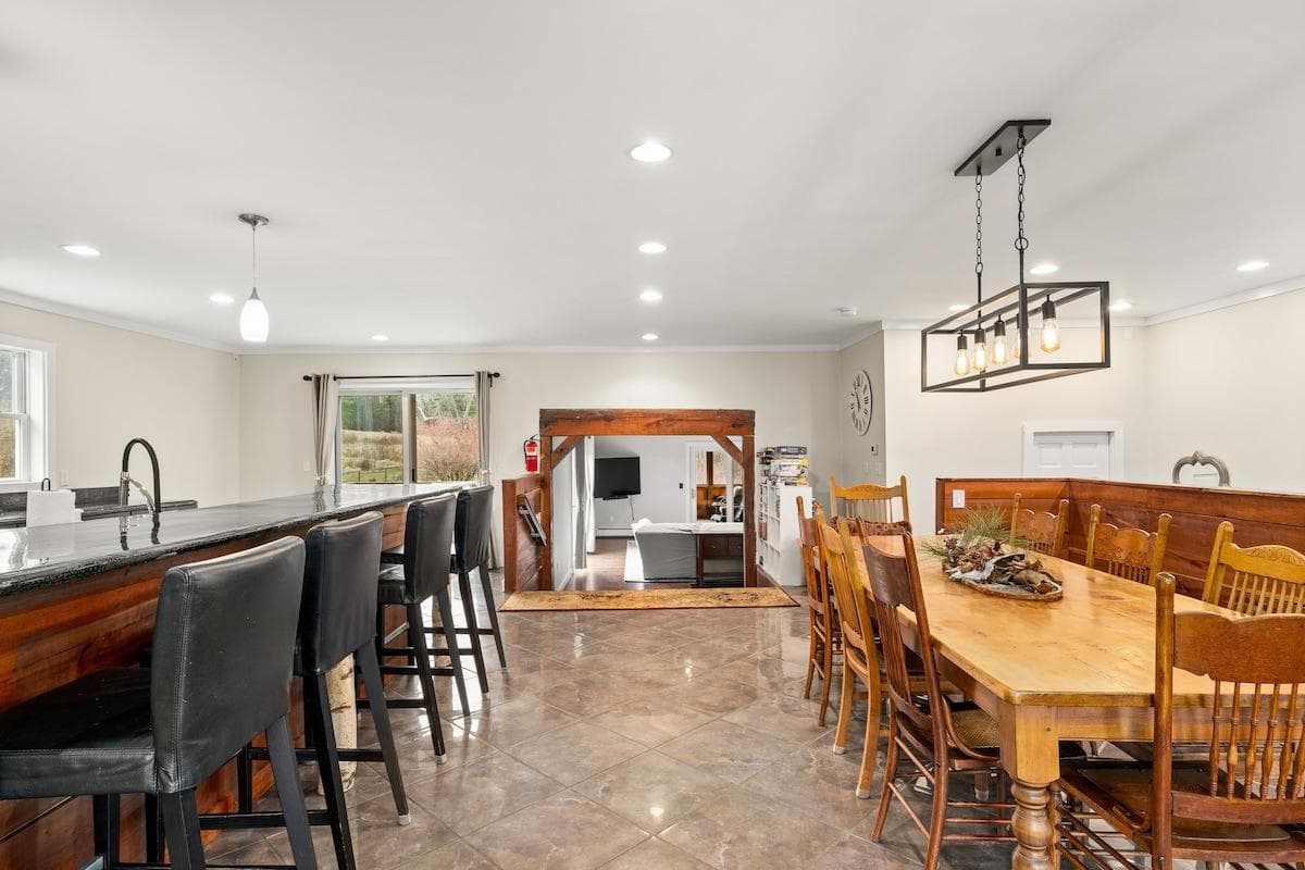 Seating for everyone (10 at the table and 4 at the countertop). Stairs lead into the main living space.