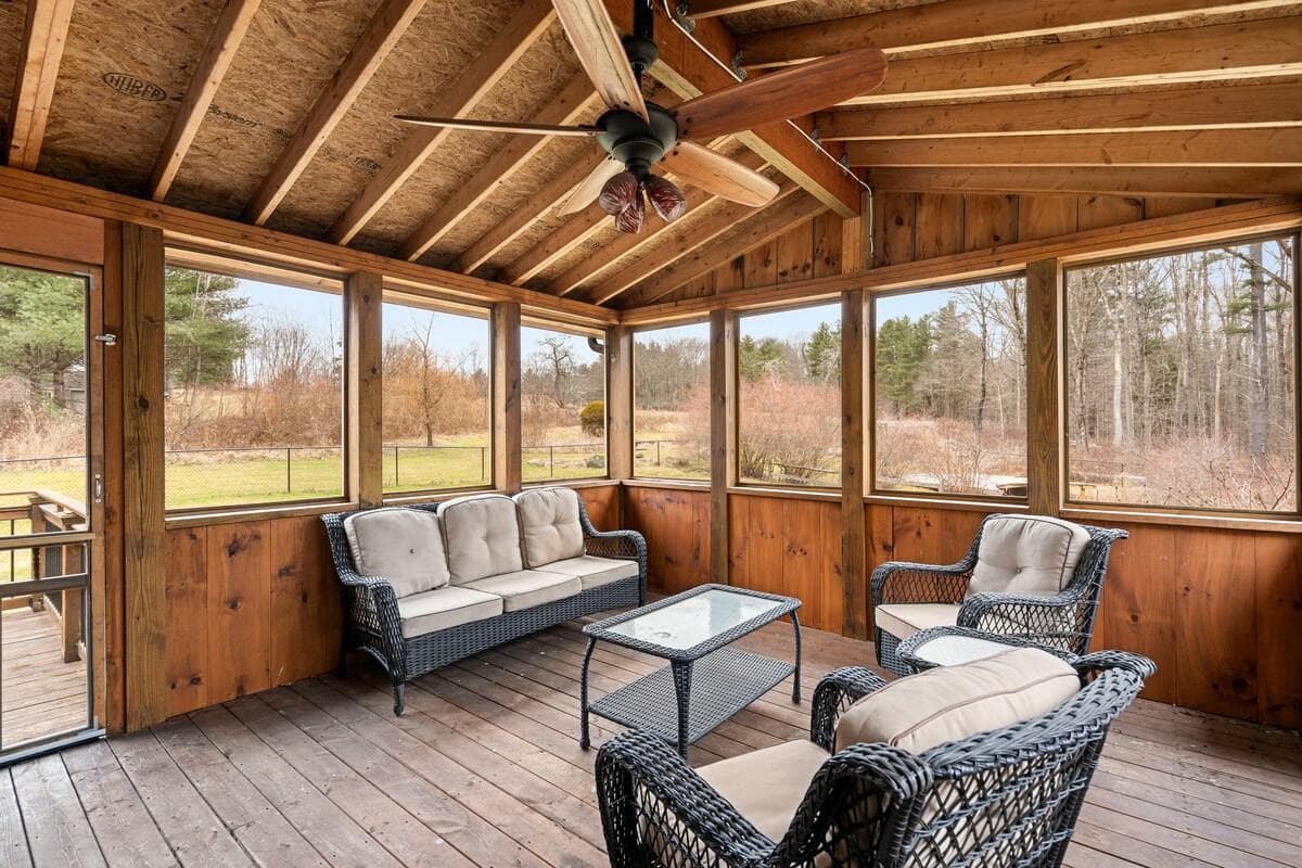 Three season porch. Sliders to the main living space. Door leads to the main porch that opens to the fenced in yard.