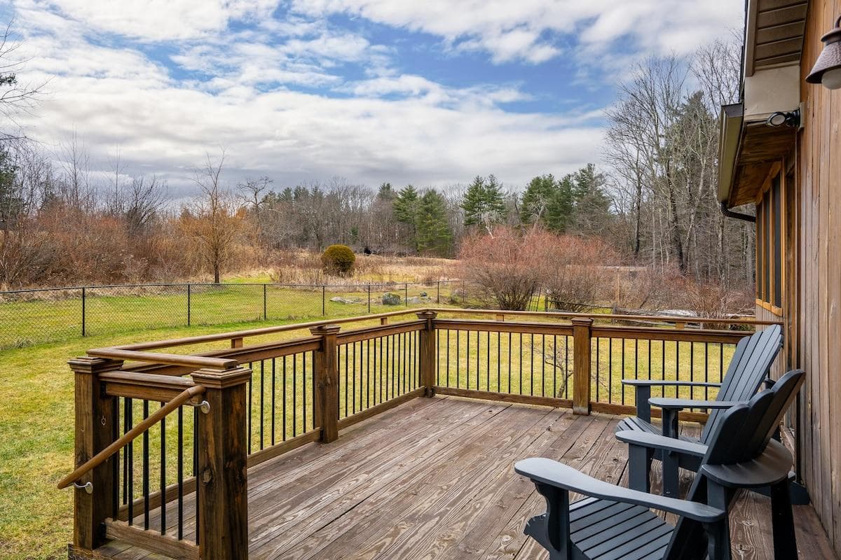 Primary deck with sliders to the main living room and kitchen. A favorite place in the spring and summer to hang out, let the kids and dogs run in the yard, and enjoy the view!